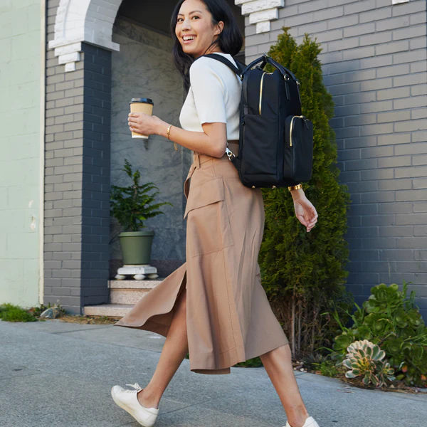 sustainable rucksack, person walking while wearing backpack and holding coffee cup