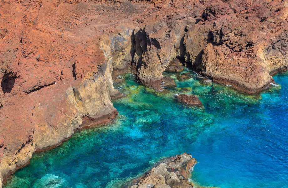 best Tenerife things to see, aerial view of jagged rocky coast with clear blue waters