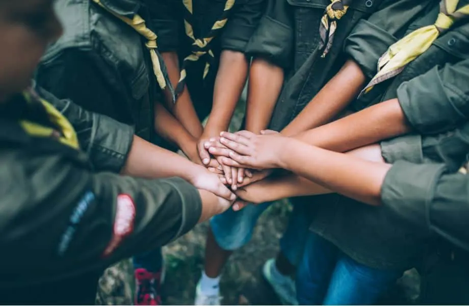 scary ghosts of Wisconsin, group of young boy scouts putting their hands together in a circle