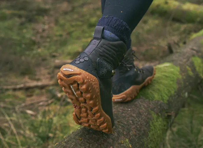 most ethically made boots, view of people's feet wearing boots walking through the forest