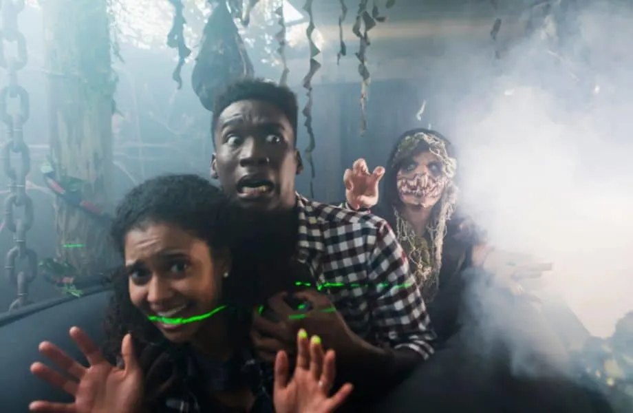 Best Wisconsin Halloween activities, two black teens running from a scary monster in a haunted house