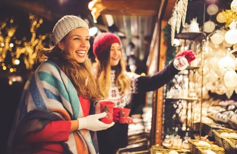 Magical Christmas market in Wisconsin, two people in winter clothes shopping at a market stall