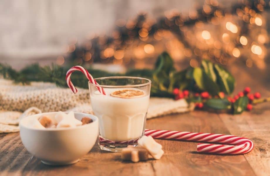 best winter festivals in Wisconsin, cup of festive coffee drink surrounded by festive things like candy canes and mistletoe