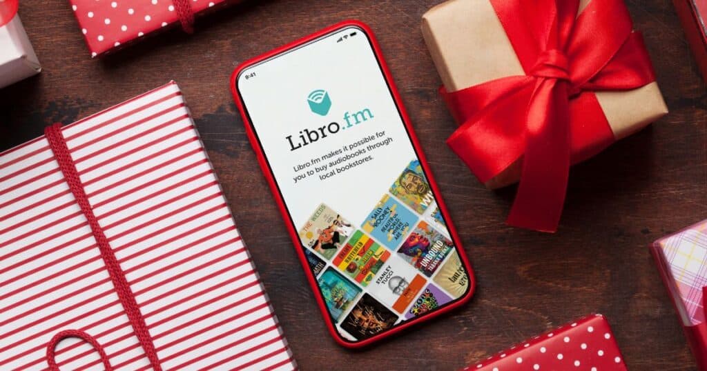 best eco gifts for book lovers, phone with libro.fm app open surrounded by wrapped gifts