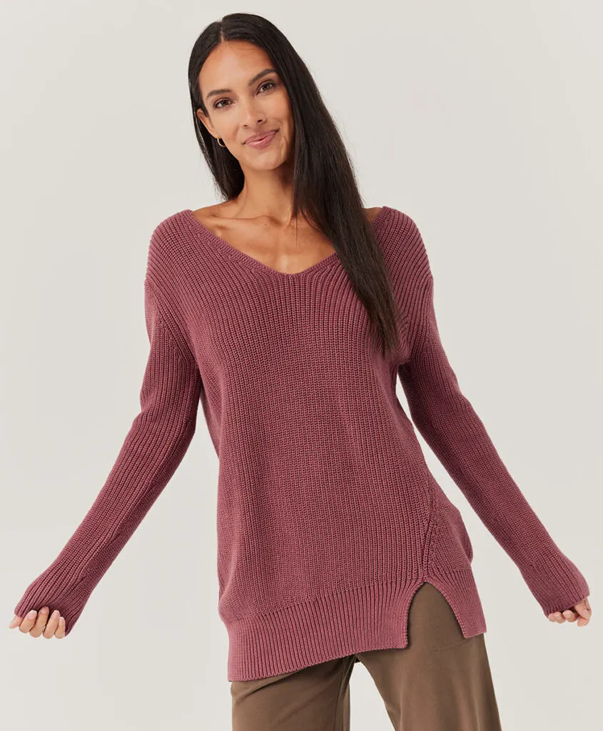amazing environmental Christmas gifts, latine woman wearing red wine colored knit sweater
