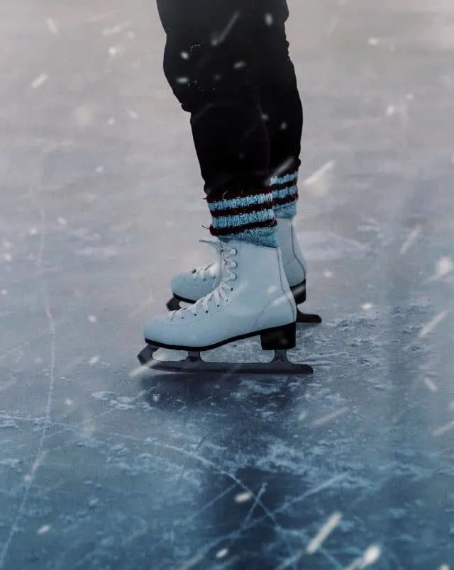 fun things to do in Milwaukee in winter, feet of someone ice skating on clear, thick ice