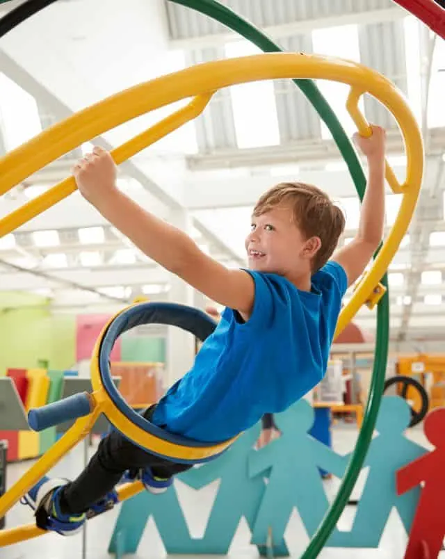 Wisconsin Dells attractions for families, young child playing on interactive display inside museum