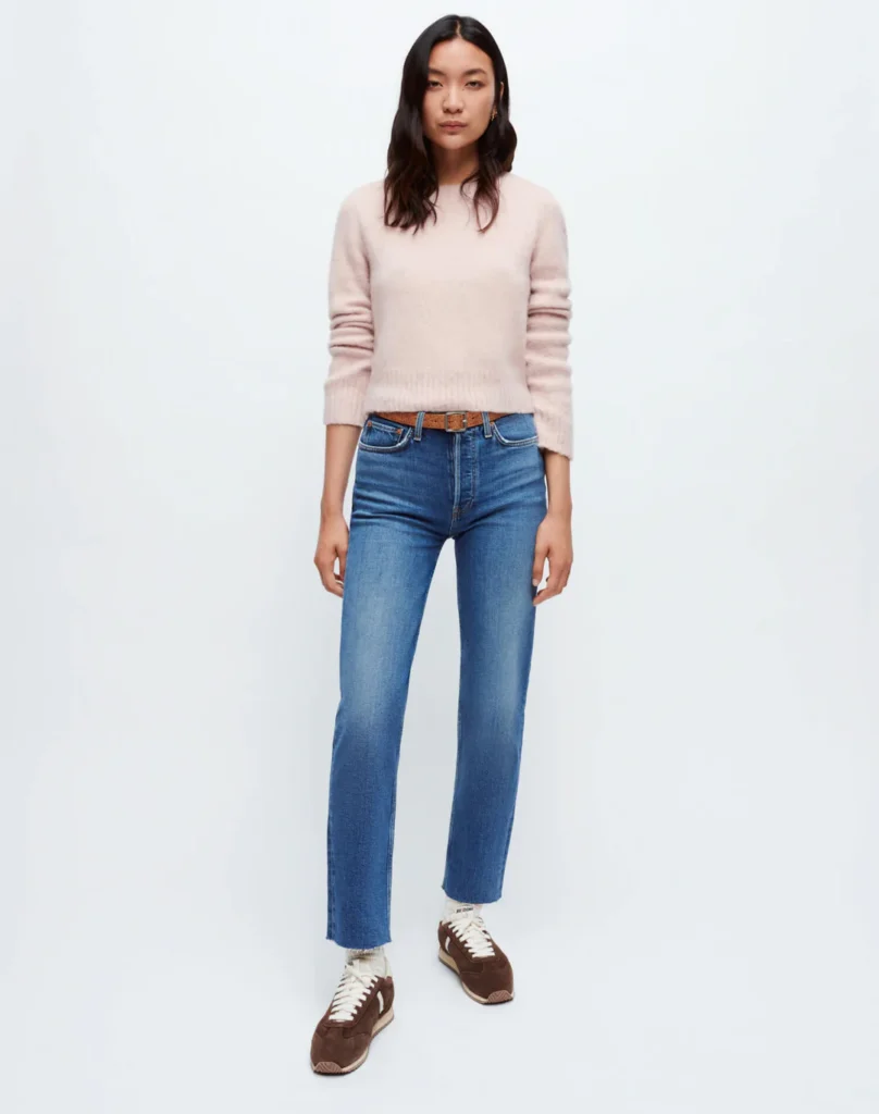 sustainable jeans womens, east asian woman wearing pink sweater and blue jeans