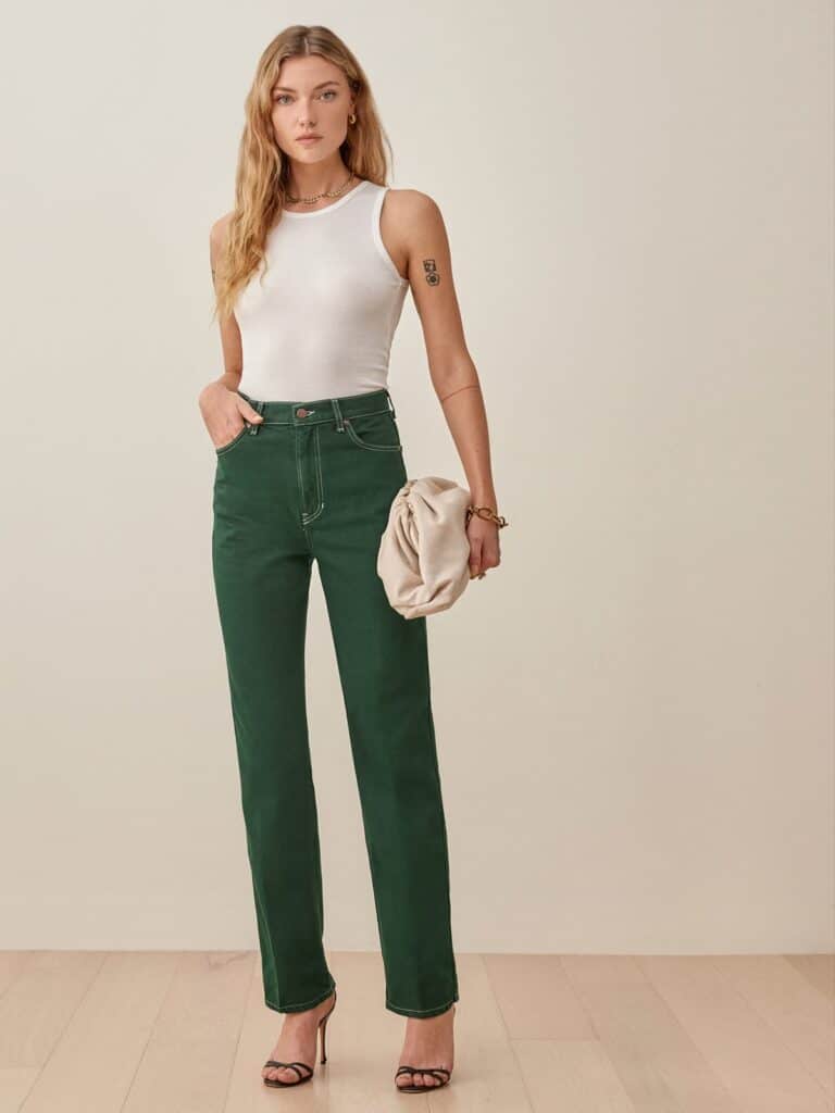 sustainable denim jeans, white woman wearing white tank top and green jeans