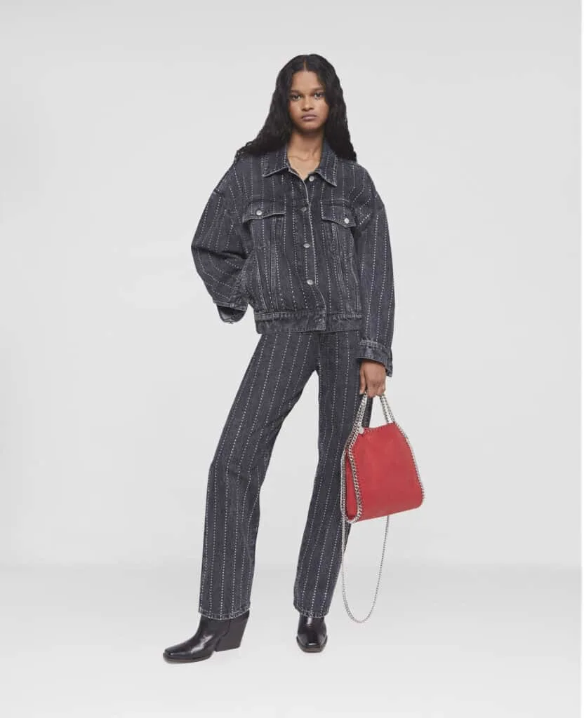 best sustainable jean brands, southeast asian woman wearing matching black and white striped jeans and denim jacket