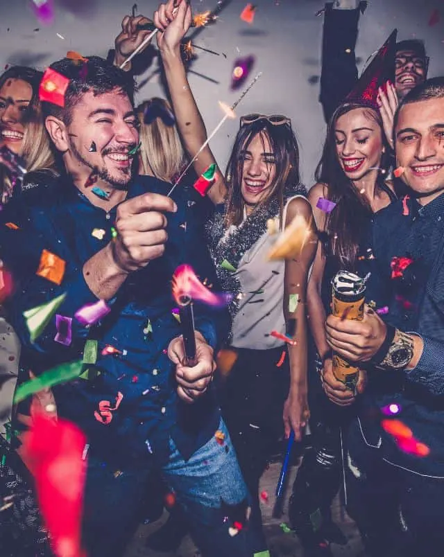 things to do in the south of Tenerife at night, group of people clubbing with lots of confetti in the air