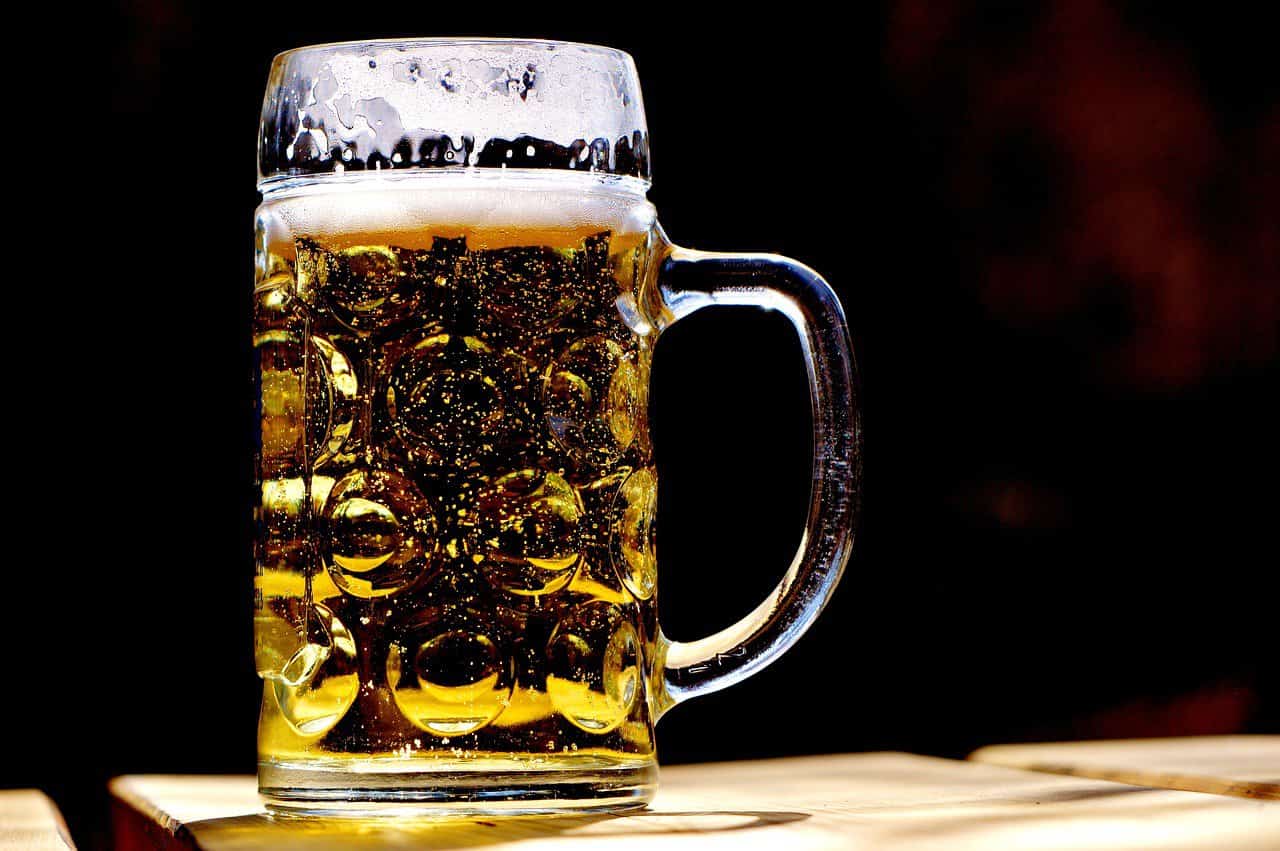 a glass of beer on a table with a black background in a madison brewery