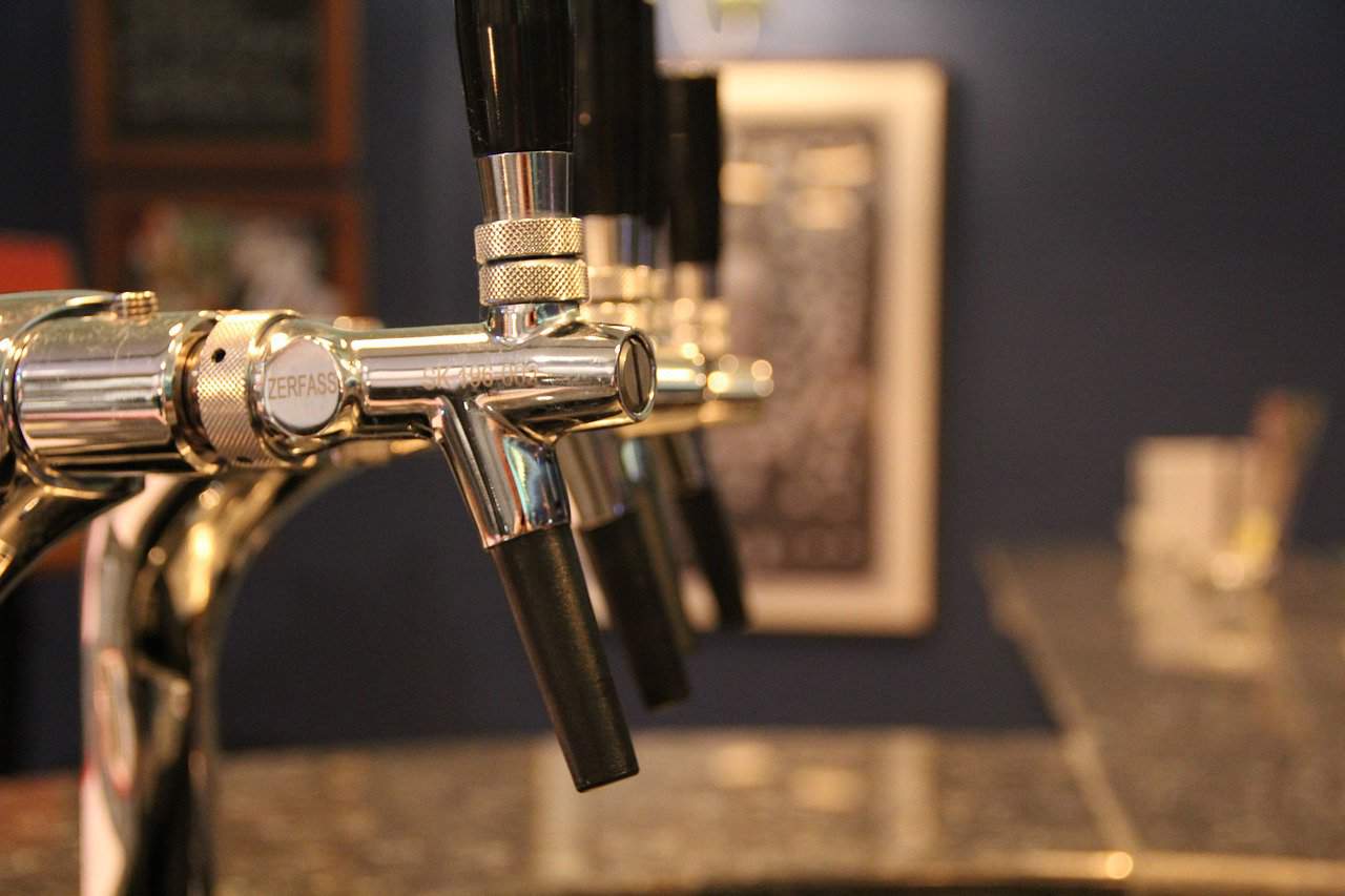 a close up of beer taps
