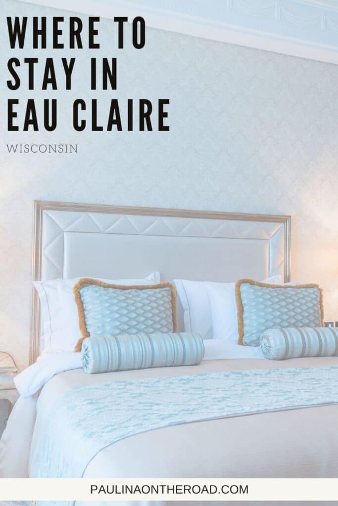 Pin with image of bed in hotel room with blue and white bedding, text in upper left corner reads "Where to stay in Eau Claire, Wisconsin"