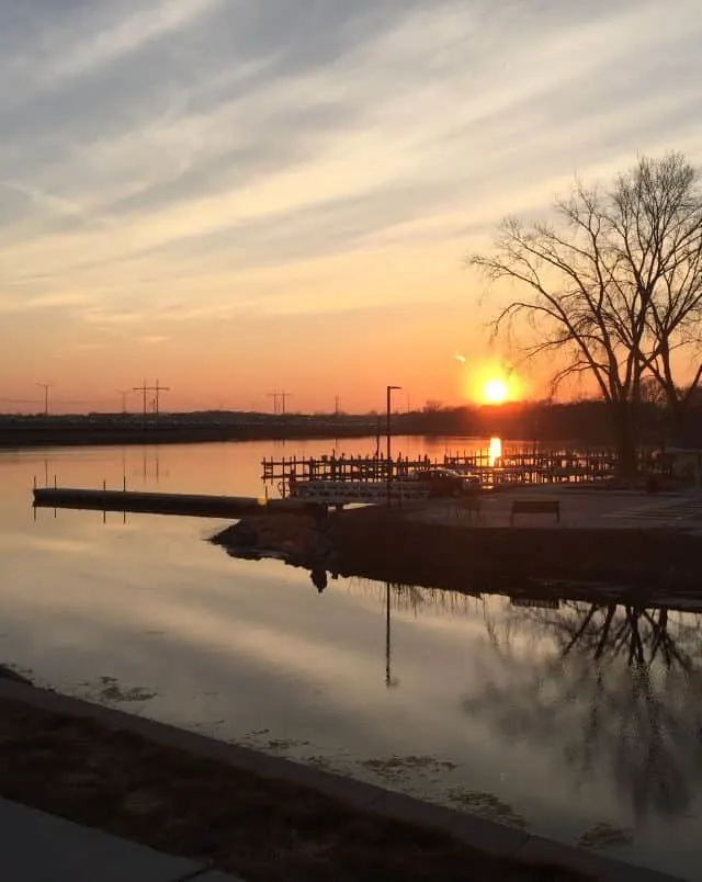 top hiking trails in Madison, view from lakeside trail over lake and pier at sunset