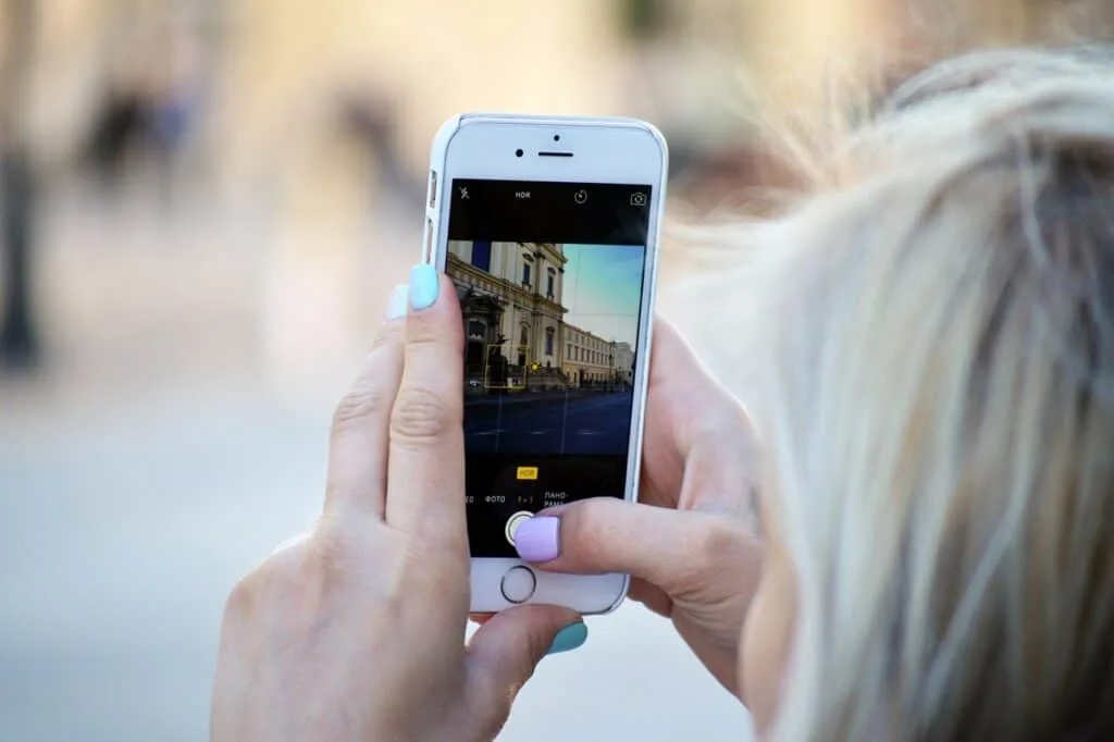 woman using phone while traveling with the best esim in france