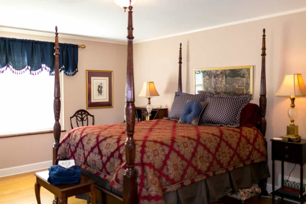 best adults-only hotels Wisconsin offerrs, room with four poster bed decorated with red print comforter