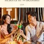Pin with image of a southeast Asian woman and man sitting in a fancy booth and cheersing each other with cocktails , text above image reads '10 Best adult-only resorts in Wisconsin