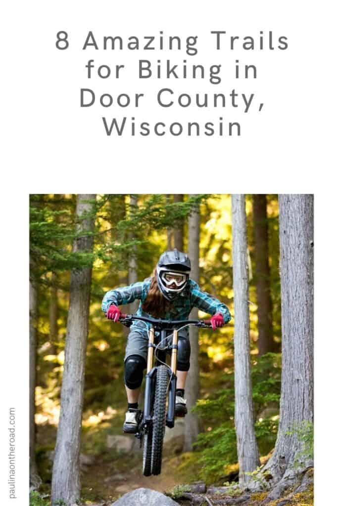 Pin with an image of a person mountain biking through the woods, bike is currently in the air, text above image reads: 8 amazing trails for biking in Door County, Wisconsin