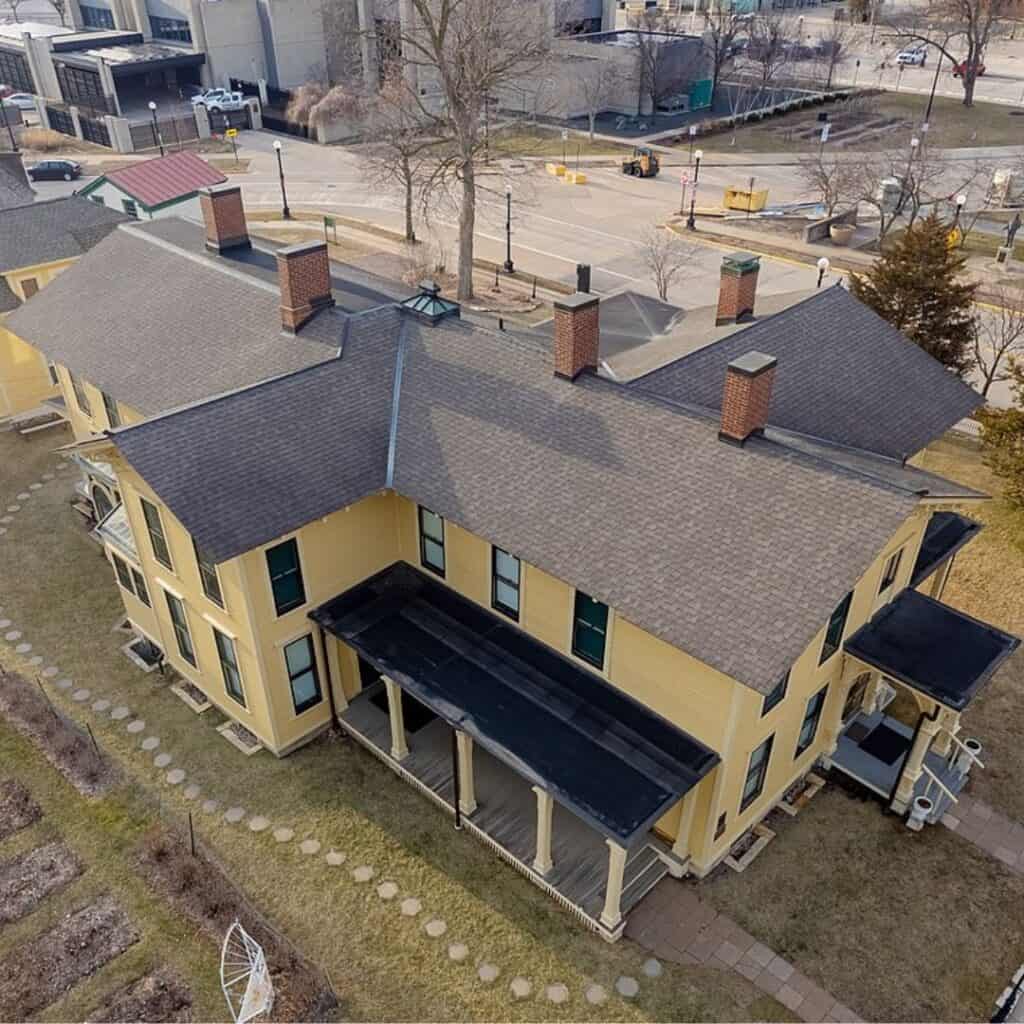 an aerial view of an old yellow house