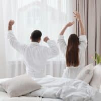 couple in bathrobes waking up in a resort in Wisconsin for couples