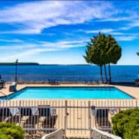 view with the pool and lake at Westwood Shores Waterfront Resort - Sturgeon Bay