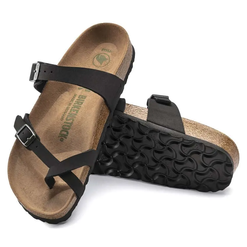 vegan Birkenstock sandals, two black strap sandals with suede-looking base, one is on its side while the other is propped up on it
