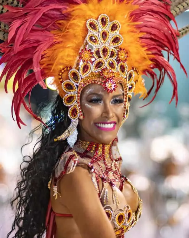 Fun Puerto de la Cruz things to do, Smiling woman in brightly coloured ornate carnival dress and red and orange headdress