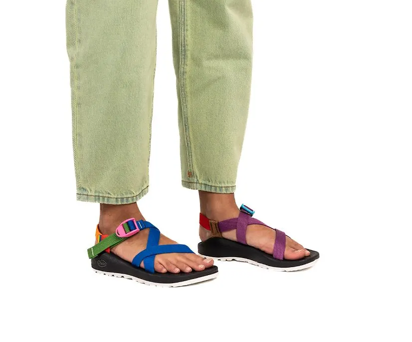 women’s vegan sandals, bottom legs of someone wearing sporty sandals with rainbow colored straps