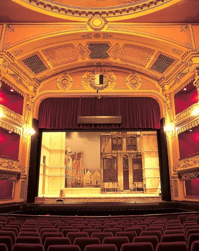 Best Oshkosh events, Interior of large ornate opera house with seats leading across to a stage with ornate decorations and an arched ceiling with box seats off to the sides