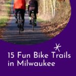 Pin with image of two people bikign along a paved bike path during fall, text below image reads: 15 fun bike trails in Milwaukee Wisconsin