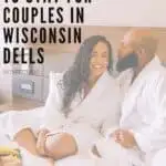 Pin with an image of a black couple wearing robes and enjoying room service in bed, text over pin reads: best places to stay for couples in Wisconin Dells Wisconsin