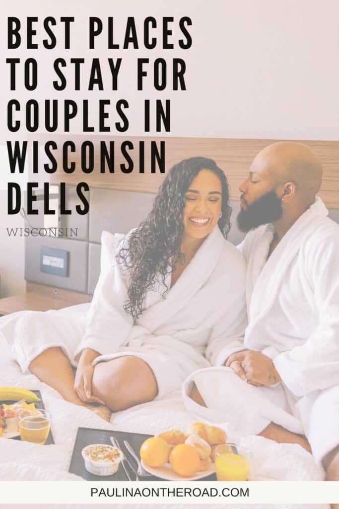 Pin with an image of a black couple wearing robes and enjoying room service in bed, text over pin reads: best places to stay for couples in Wisconin Dells Wisconsin