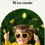 Pin with image of a small kid wearing a yellow shirt and yellow heart sunglasses giving a thumbs up while lying in green grass with yellow leaves, text above image reads: 10 fun things to do in Oshkosh Wisconsin