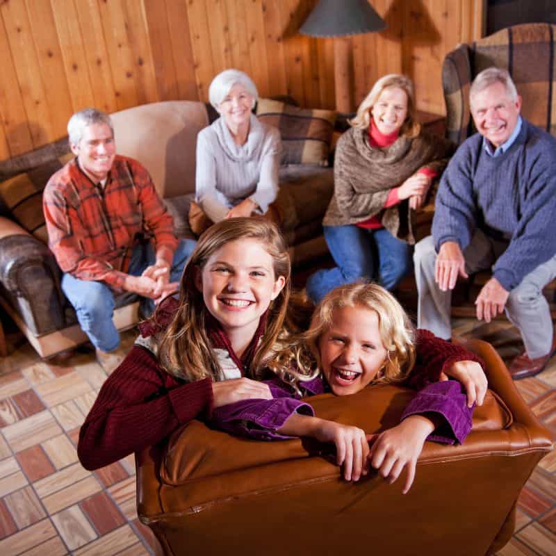 a big family posting in a rustic living room at one of the best family cabins in Wisconsin