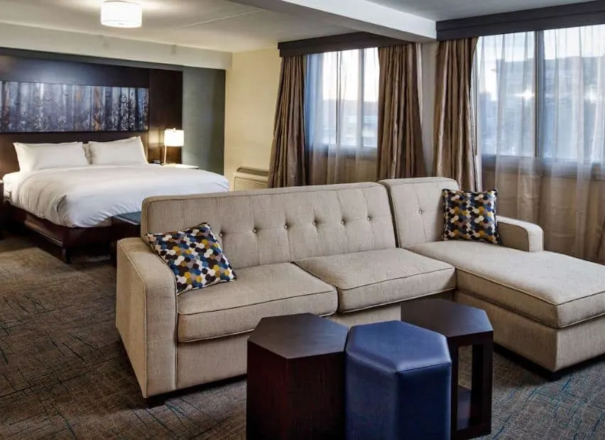 a guest suite with a bed and a sofa at DoubleTree by Hilton Neenah Wisconsin - 12 Best Resorts on Lake Winnebago, Wisconsin