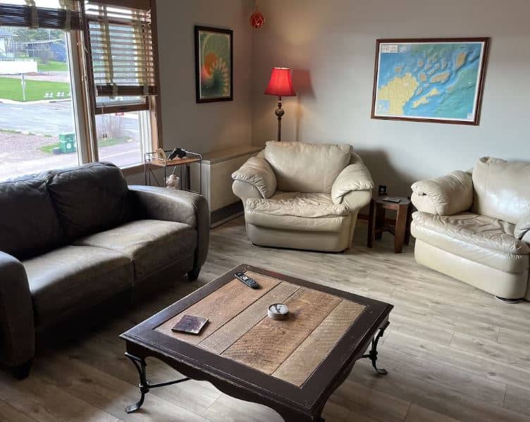 a living room with cozy sofas at the Downtown Island Condo Apostle Islands - 14 Unique Airbnbs in Apostle Islands