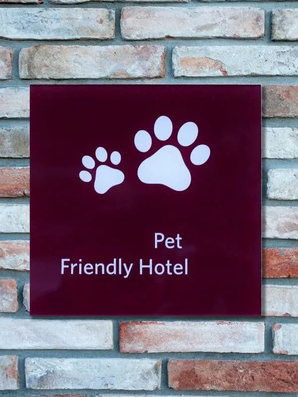a sign with pet friendly hotel on a hotel wall in Lake Geneva. Best pet-friendly hotels in Lake Geneva