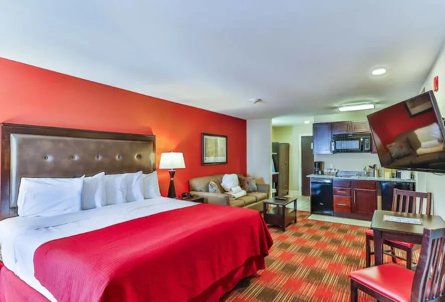 a studio room at Polynesian Hotel Wisconsin Dells with a bed sofa and a small kitchen - 10 Great Pet-Friendly Resorts in Wisconsin Dells