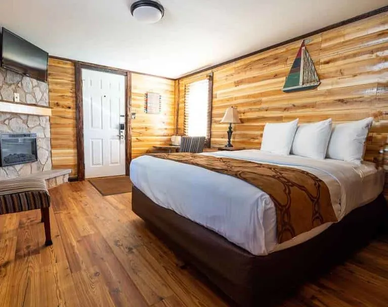 bedroom with wooden walls at Lake Geneva Lodge best pet friendly hotels in Lake Geneva - 10 Best Pet-Friendly Hotels in Lake Geneva, Wisconsin