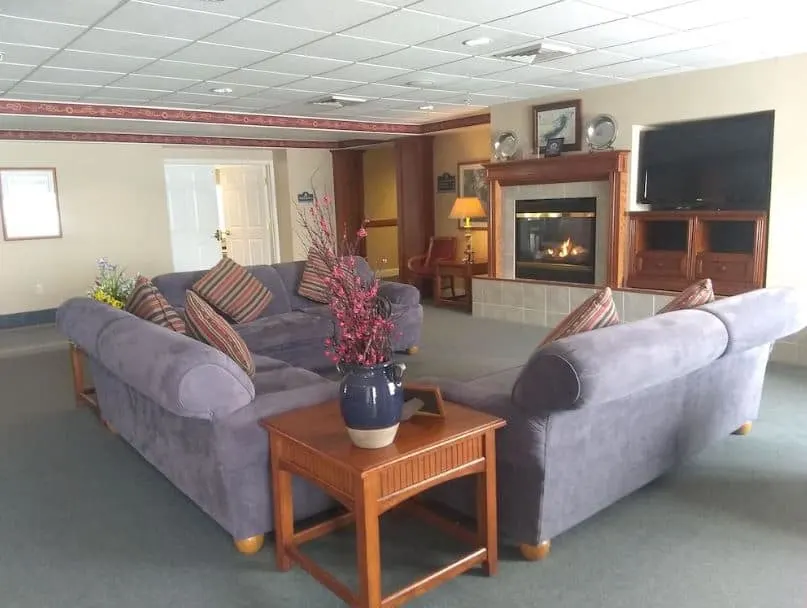 living room with fire place sofa and a tv at the Family Friendly Retreat with Water Views Lake Geneva - 10 Best Airbnbs in Lake Geneva, Wisconsin