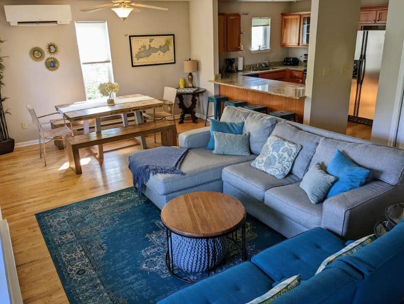 living room with sofa table and open kitchen at Hazels Hideaway one of the best airbnbs in Lake Geneva Wisconsin - 10 Best Airbnbs in Lake Geneva, Wisconsin