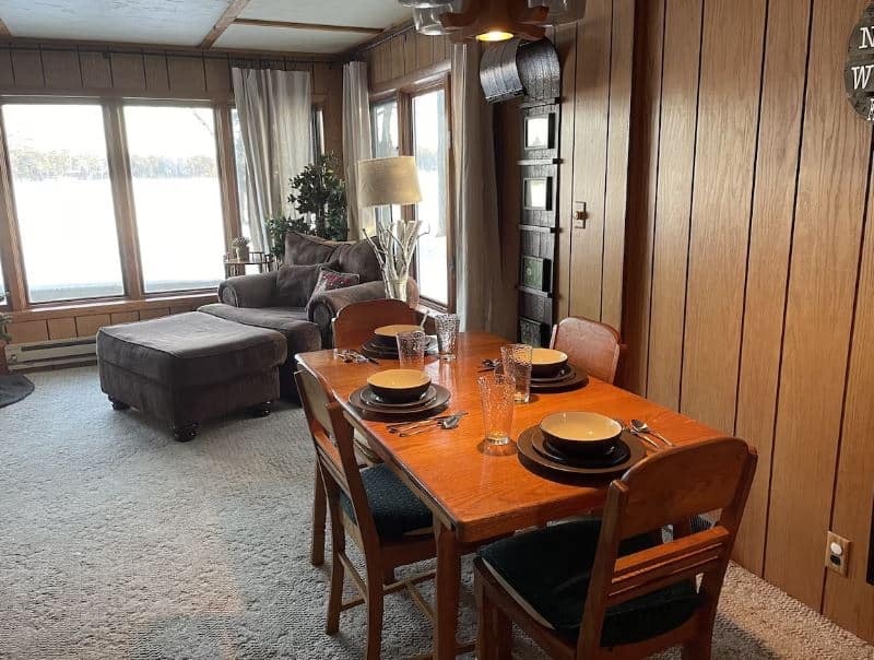 living room with table and sofa at Quiet Waterfront Cabin in Minocqua Wisconsin - 13 Best Lake Cabins in Wisconsin
