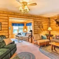 rustic interior with wooden walls and sofas at one of the best cozy cabins in Wisconsin