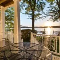 view with the lake at sunset from the Adorable beautiful garden right by the lake with green areas at Northern Wisconsin Resorts on Lakes