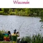 a pin with a couple fishing by the lake at one of the best fishing resorts in Wisconsin.