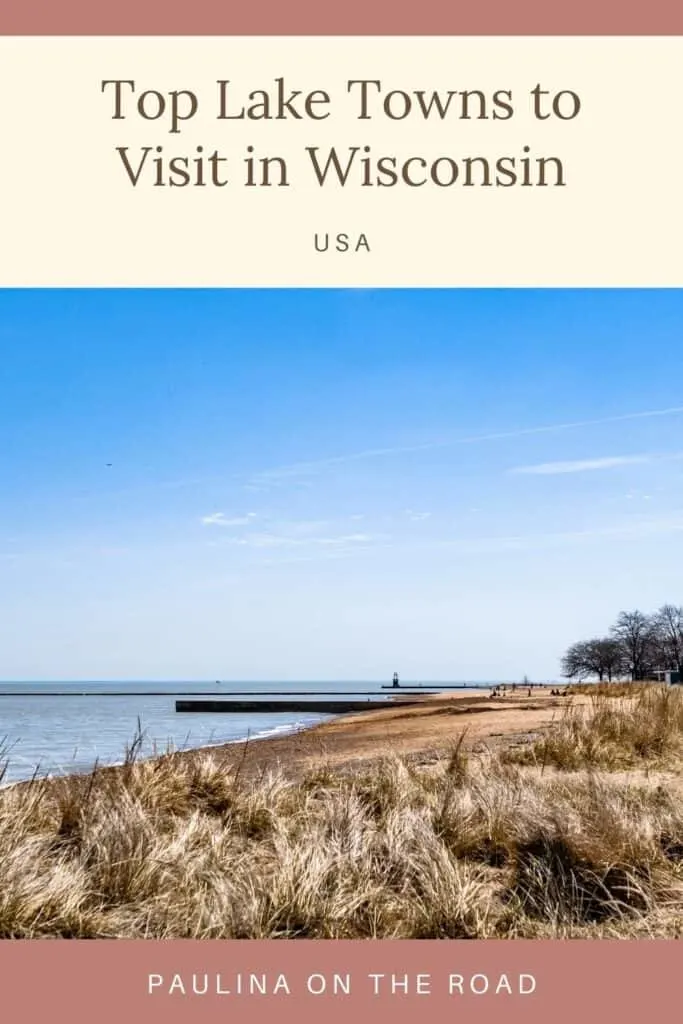 Pin with view of long sandy beach with pale green long grass and periodic wooden jetties under a bright blue sky, caption reads: Top Lake Towns to Visit in Wisconsin USA by Pauline on the Road