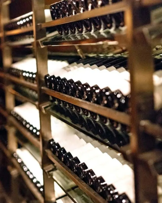 wineries in southern Wisconsin, Close up shot of a large wooden rack containing many rows of bottles of wine