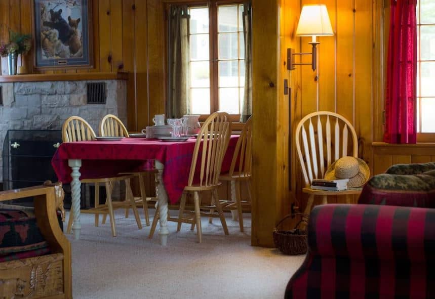 cozy living room with dining table, sofa and fire place at the Black Bear Lodge & Resort, St. Germain, Wisconsin