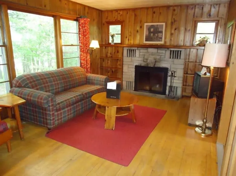cozy living room with sofa and fire place at the Holiday Acres Resort on Lake Thompson Wisconsin - 12 Best Pet-Friendly Resorts in Wisconsin